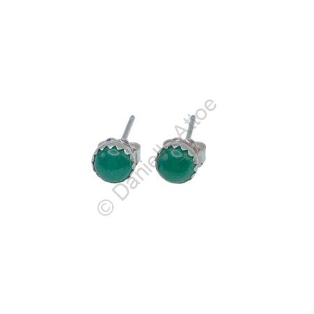 Earrings featuring a round green stone set in a silver bezel on sterling silver posts.