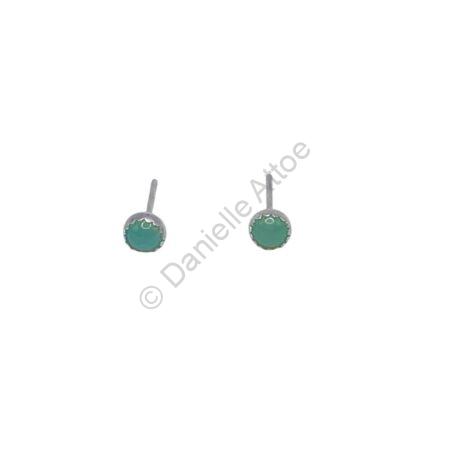 Sterling silver earrings featuring small, round green stones on posts.